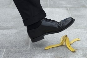 Businessman about to step on a banana skin